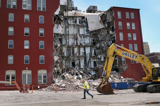 PHOTO: A worker walks by a six-story apartment building after it collapsed on May 28, 2023 in Davenport, Iowa. (Scott Olson/Getty Images)