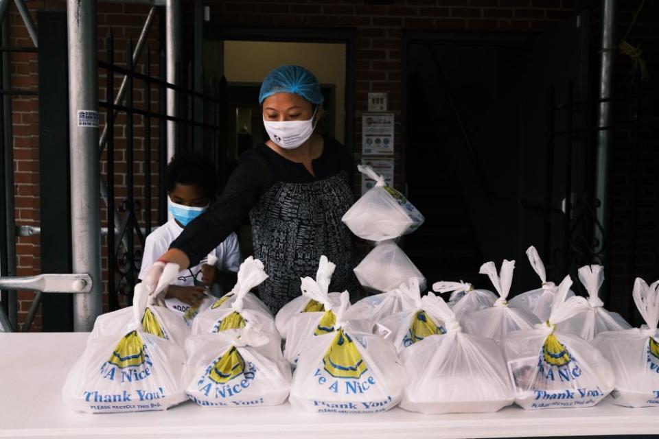 Meals are prepared and placed on. an outdoor table for people to receive in New York, New York, on 22 October.