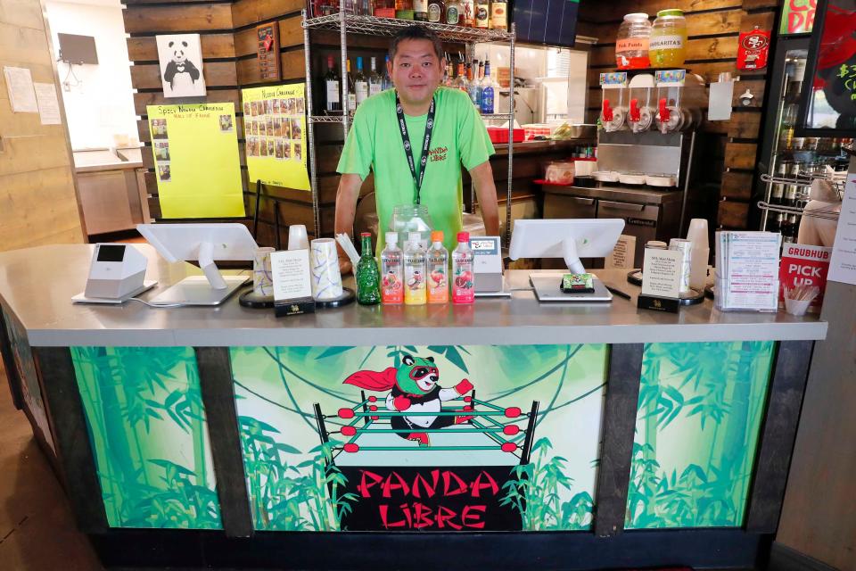 Paul Fan, owner of Panda Libre, stands behind the counter of his Gilbert restaurant. The Mexican-Asian fusion restaurant was embroiled in a legal battle with Panda Express over its name and logo in 2020.