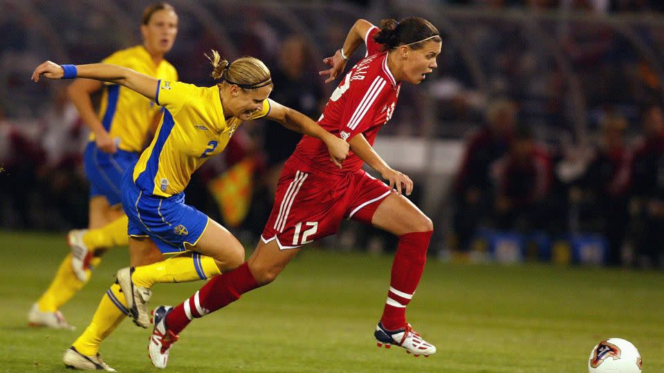 Sinclair dribbles against Sweden's Karolina Westberg during the semifinals of the 2003 Women's World Cup. - Ben Radford/Getty Images