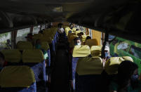 Commuters ride a bus with seat arrangements for social distancing following the easing of the lockdown to prevent the spreading of the new coronavirus in Manila, Philippines Tuesday, June 2, 2020. The Philippine capital has shifted to a more relaxed quarantine with limited public transport in a high-stakes gamble to slowly reopen the economy while fighting the coronavirus outbreak. (AP Photo/Aaron Favila)