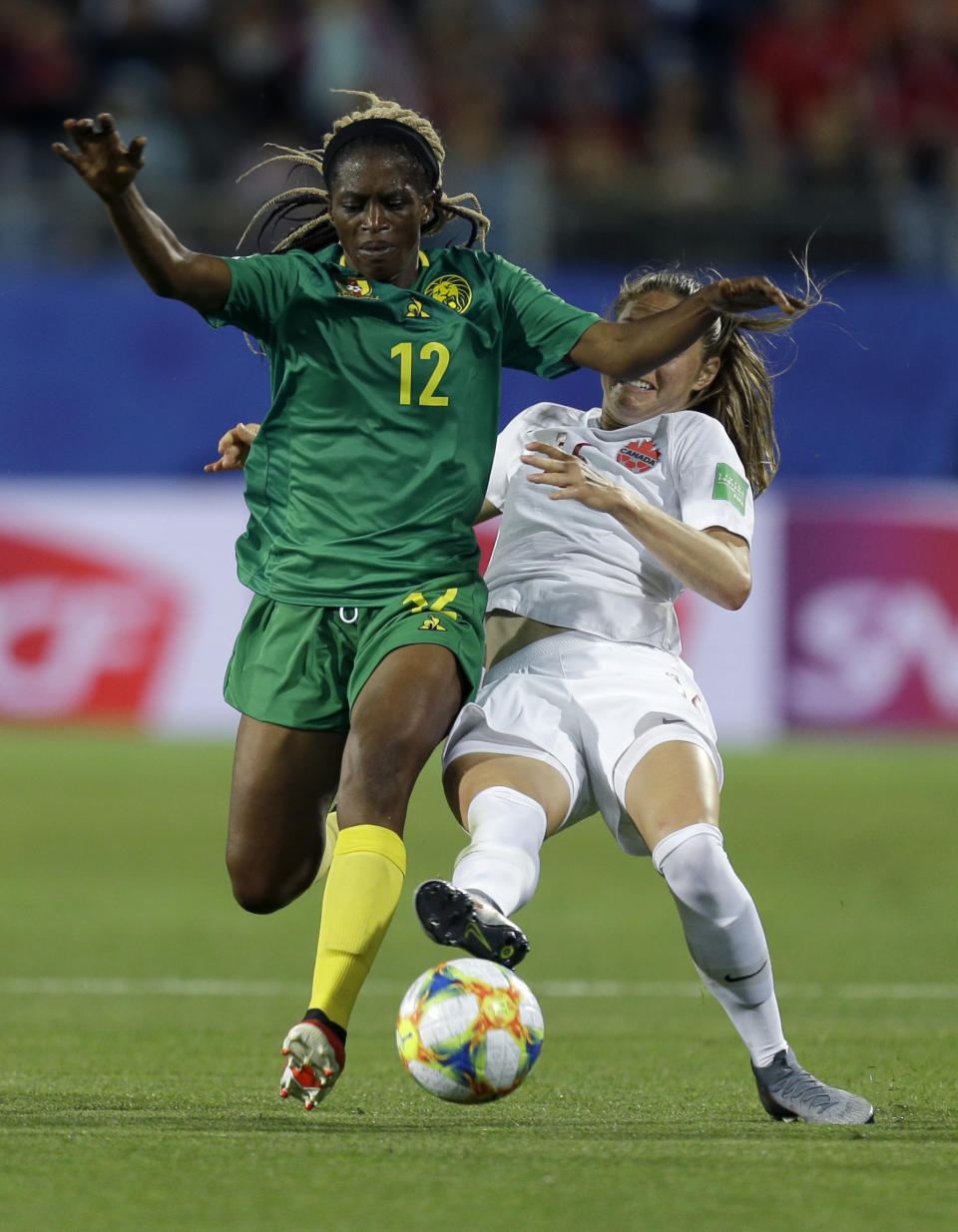 Cameroon's Claudine Meffometou, left, and Canada's Janine Beckie battle for the ball during the Women's World Cup Group E soccer match between Canada and Cameroon in Montpellier, France, Monday, June 10, 2019. (AP Photo/Claude Paris)