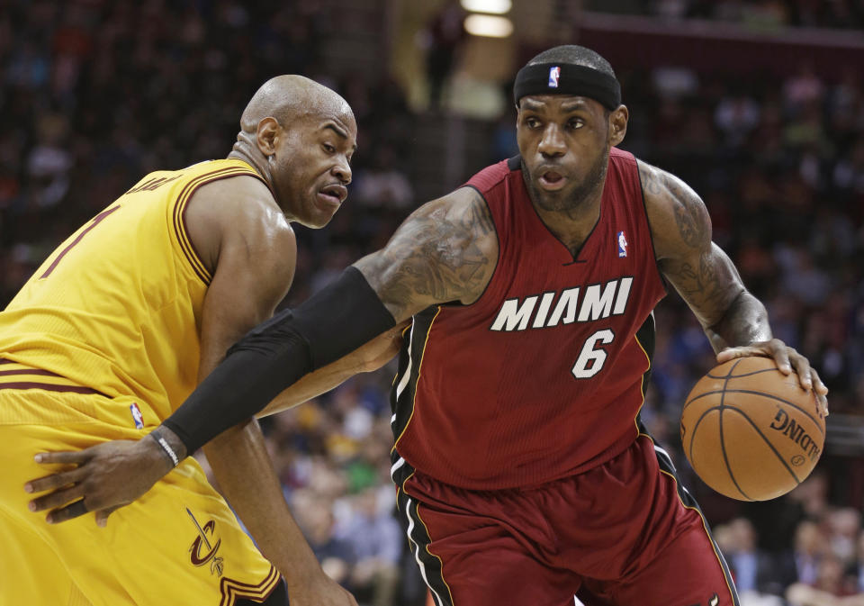 Miami Heat's LeBron James, right, drives around Cleveland Cavaliers' Jarrett Jack during the second quarter of an NBA basketball game Tuesday, March 18, 2014, in Cleveland. (AP Photo/Tony Dejak)