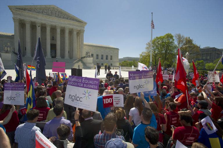 Supporters and opposers of same sex marriage gather outside the US Supreme Court as hearings happen inside concerning marriage equality, April 28, 2015 in Washington, DC