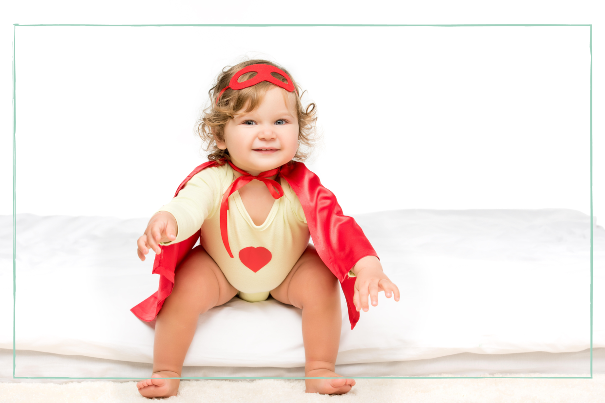  Baby girl in a cape to represent baby names inspired by feminists for 2024. 