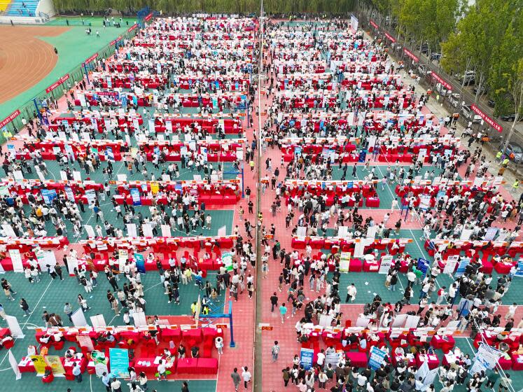 QINGDAO, CHINA - SEPTEMBER 23, 2023 - College students look for suitable positions at the autumn campus double selection fair of Shandong University of Science and Technology in Qingdao, Shandong province, China, Sept 23, 2023. (Photo credit should read CFOTO/Future Publishing via Getty Images)