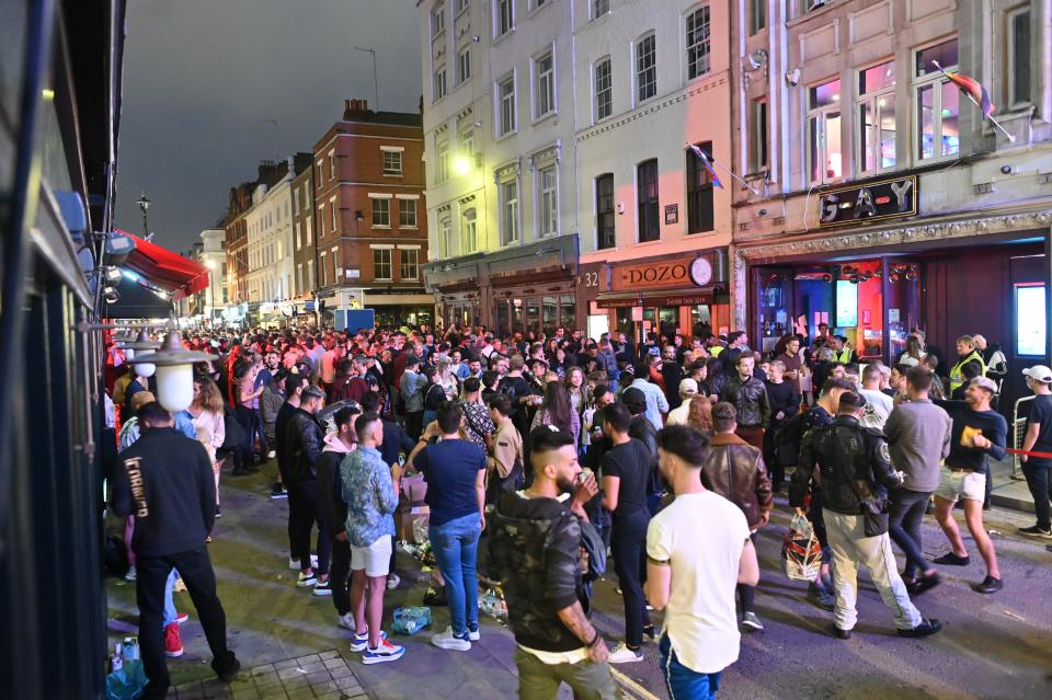 Revellers crowd the street outside bars in the Soho area of London on July 4, 2020, as restrictions are further eased during the novel coronavirus COVID-19 pandemic. - Pubs in England reopen on Saturday for the first time since late March, bringing cheer to drinkers and the industry but fears of public disorder and fresh coronavirus cases. (Photo by JUSTIN TALLIS / AFP) (Photo by JUSTIN TALLIS/AFP via Getty Images)