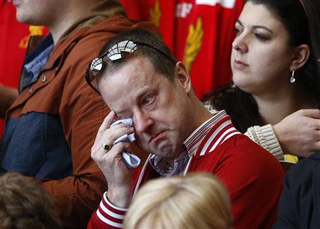 A man weeps during a memorial service to mark the 25th anniversary of the Hillsborough disaster at Anfield in Liverpool, northern England April 15, 2014. REUTERS/Darren Staples