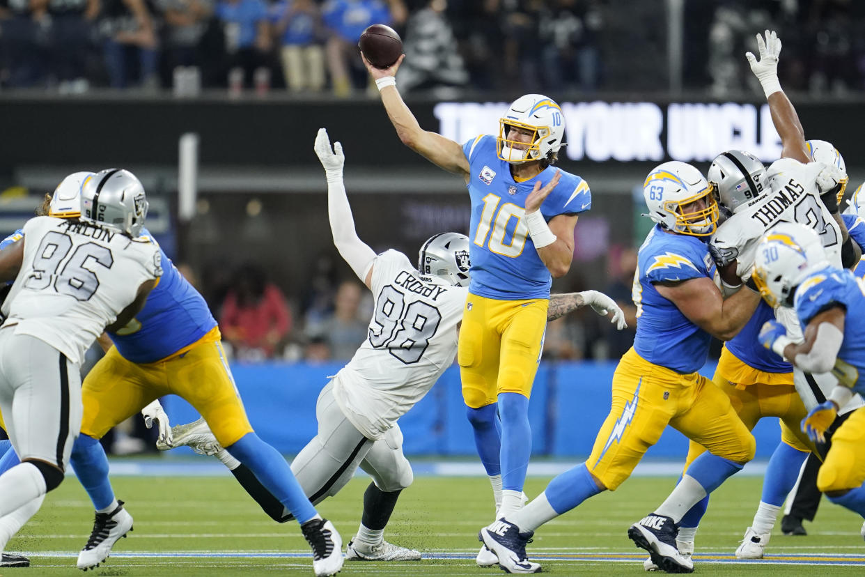 Los Angeles Chargers quarterback Justin Herbert (10) throws a pass during the first half of an NFL football game against the Las Vegas Raiders, Monday, Oct. 4, 2021, in Inglewood, Calif. (AP Photo/Marcio Jose Sanchez)