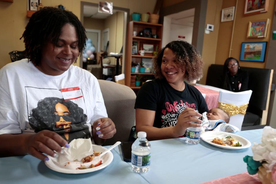 (L to R) Nita Brown, 34, of Detroit and nine months pregnant and Serenity Jackson, 22, of Detroit with her 6-week-old son, Samuel Metoyer, talk during a baby shower Lesley and Robert Gant of Because of His Love Outreach hosted at Harmony Café in Detroit on May 20, 2023. The Gants hosted the shower for expecting parents and moms who had recently given birth, and had a raffle of baby items and gift bags full of diapers and other baby supplies.