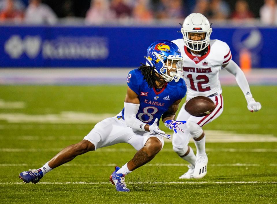 Kansas wide receiver Kwamie Lassiter II (8) catches a pass against South Dakota Coyotes defensive back Tre Jackson (12) during the second half of a game at David Booth Kansas Memorial Stadium on Sept. 3, 2021.
