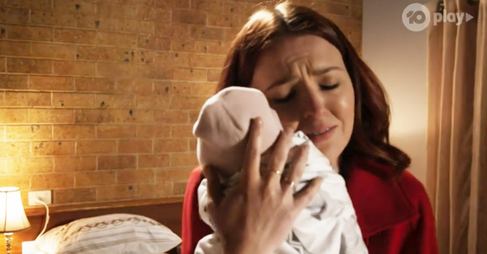 Neighbours actor Charlotte Chimes in character as Nicolette Stone with her baby Isla