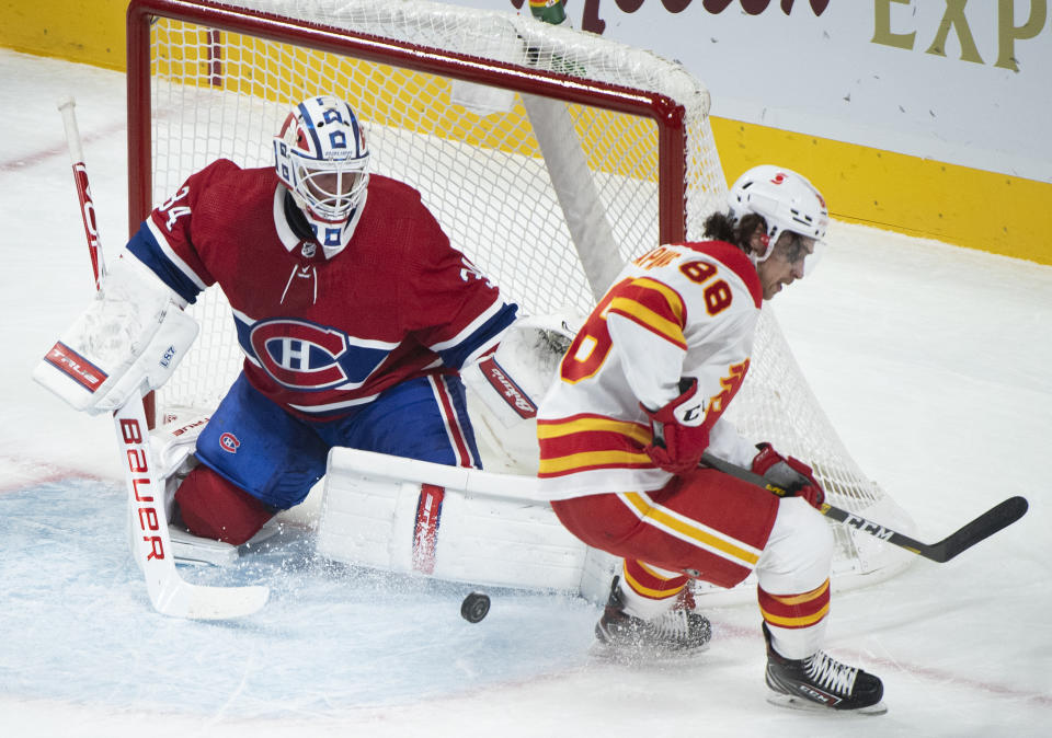 Calgary Flames' Andrew Mangiapane (88) moves in on Montreal Canadiens goaltender Jake Allen during first-period NHL hockey game action in Montreal, Saturday, Jan. 30, 2021. (Graham Hughes/The Canadian Press via AP)