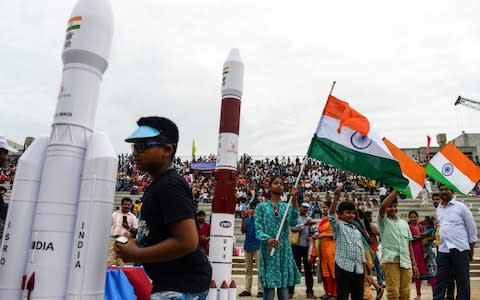 Students wave Indian national flags to celebrate the launch of Chandrayaan-2 - Credit: ARUN SANKAR/AFP/Getty Images