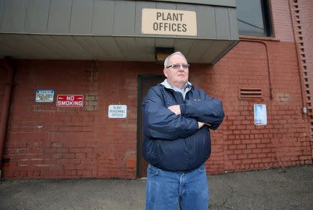 Unemployed autoworker Donald Coy, who was laid off from Ross's auto-parts plant, when it closed its doors in December 2016, is pictured in front of the former manufacturing plant in Canton, Ohio, U.S., January 14, 2017. REUTERS/Aaron Josefczyk