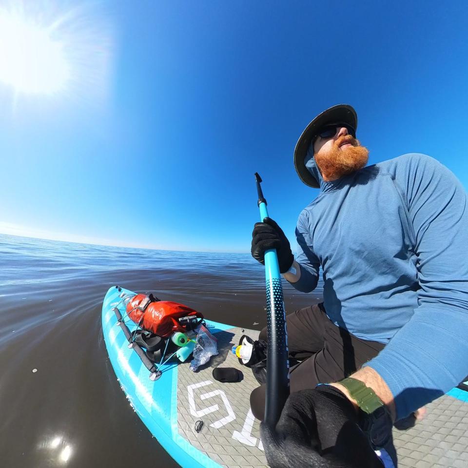 Mason Gravley sits atop his board during his excursion across Lake Okeechobee with a friend, Jordon Wolfram, on Dec. 31. The journey took them more than 10 hours.