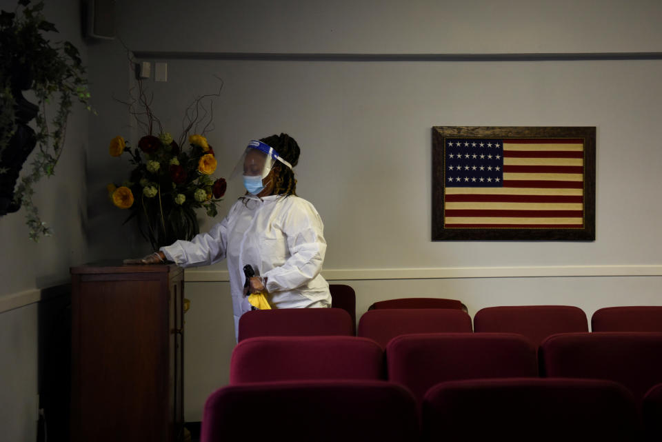 Shayla Williams, 39, disinfects surfaces to prevent the spread of COVID-19 at Beresford Funeral Service in Houston. (Callaghan O'Hare/Reuters)