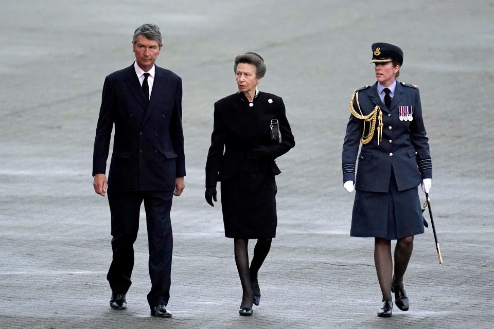 Britain's Princess Anne, Princess Royal, (C) and Vice Admiral Timothy Laurence (L) are greeted by Station Commander Group Captain McPhaden (R) having disembarked from the C-17 carrying the coffin of Queen Elizabeth II at the Royal Air Force Northolt airbase on September 13, 2022, before it is taken to Buckingham Palace, to rest in the Bow Room. - Mourners in Edinburgh filed past the coffin of Queen Elizabeth II through the night, before the monarch's coffin returns to London to Lie in State ahead of her funeral on September 19. (Photo by Andrew Matthews / POOL / AFP) (Photo by ANDREW MATTHEWS/POOL/AFP via Getty Images)