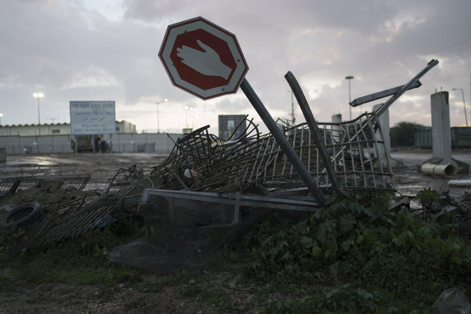 A damaged fence and a stop sign following the Oct. 7 Hamas attack on Israel is seen in front of the Erez crossing at the Israeli-Gaza border, southern Israel, Tuesday, Jan. 2, 2024. (AP Photo/Leo Correa)