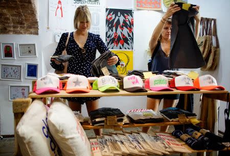 U.S. tourists look at products inside the Cuban private design store Clandestina in Havana, Cuba, October 23, 2017. REUTERS/Alexandre Meneghini