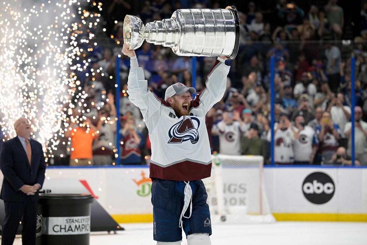 Colorado Avalanche left wing Gabriel Landeskog (92) lifts the Stanley Cup after the team defeated the Tampa Bay Lightning in Game 6 of the NHL hockey Stanley Cup Finals