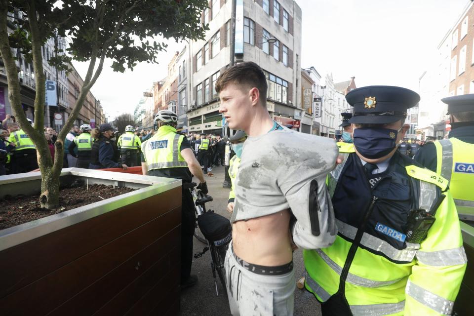 Gardai restrain a protester dring an anti-lockdown protest in Dublin city centre.PA