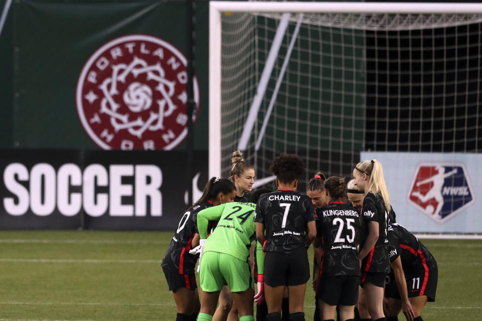 FILE - Portland Thorns FC players huddle up prior to the first half of an NWSL Challenge Cup soccer match against Kansas City Friday, April 9, 2021, in Portland, Ore. The Portland Thorns have been acquired by the Bhathal family, investors in the NBA's Sacramento Kings, the National Women's Soccer League team announced Wednesday, Jan. 3, 2024. (AP Photo/Amanda Loman, File)
