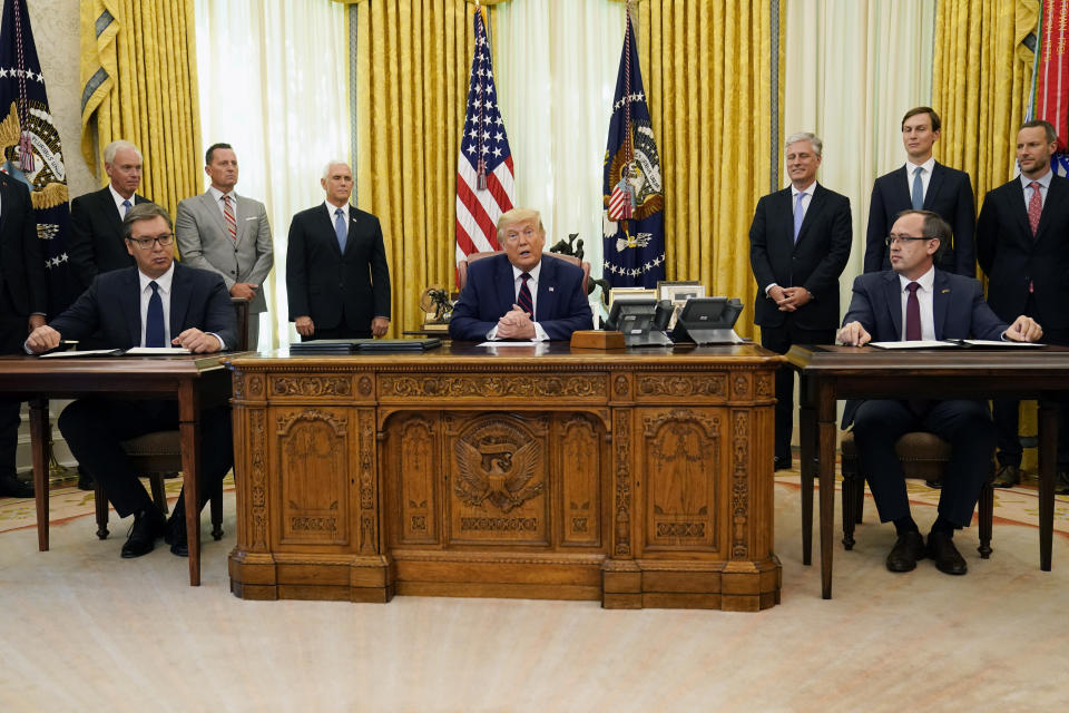 President Donald Trump participates in a signing ceremony with Serbian President Aleksandar Vucic, seated left, and Kosovar Prime Minister Avdullah Hoti, seated right, in the Oval Office of the White House, Friday, Sept. 4, 2020, in Washington. (AP Photo/Evan Vucci)