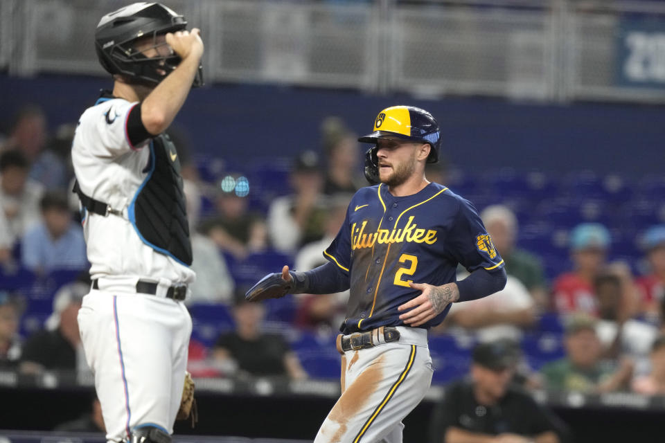 Milwaukee Brewers' Brice Turang (2) scores on a single by Tyrone Taylor during the fifth inning of a baseball game against the Miami Marlins, Sunday, Sept. 24, 2023, in Miami. (AP Photo/Lynne Sladky)