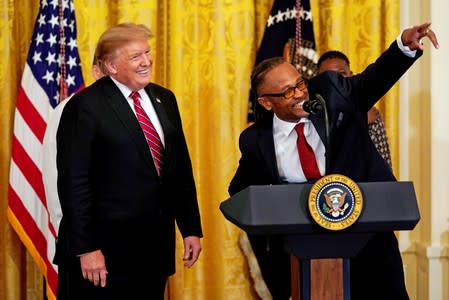 FILE PHOTO: Gregory Allen, former prisoner and FIRST STEP Act Beneficiary, speaks next to U.S. President Donald Trump during the 2019 Prison Reform Summit and First Step Act Celebration at the White House in Washington