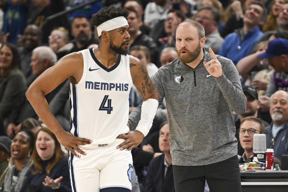 Memphis Grizzlies head coach Taylor Jenkins, right, talks with Memphis Grizzlies guard Taylor Jenkins (4) during a break in action in the first half of an NBA basketball game Wednesday, Feb 28, 2024, in Minneapolis. (AP Photo/Craig Lassig)