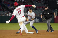 Los Angeles Angels designated hitter Shohei Ohtani, left, steals second as Houston Astros shortstop Carlos Correa, center, waits for the throw while second base umpire Todd Tichenor watches during the sixth inning of a baseball game Thursday, Sept. 23, 2021, in Anaheim, Calif. (AP Photo/Mark J. Terrill)