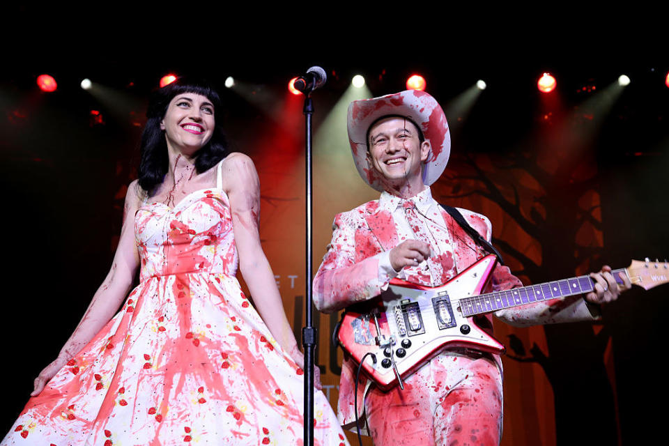 the two on stage with clothes covered in fake blood