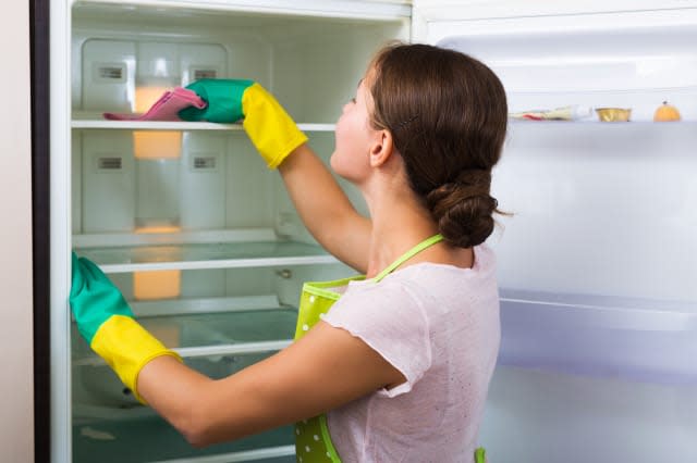 Housewife cleaning refrigerator