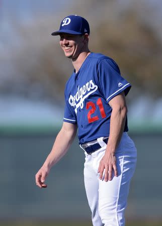 FILE PHOTO: Mar 8, 2019; Phoenix, AZ, USA; Los Angeles Dodgers starting pitcher Walker Buehler (21) laughs during warmups before the game against the Kansas City Royals at Camelback Ranch. Mandatory Credit: Orlando Ramirez-USA TODAY Sports