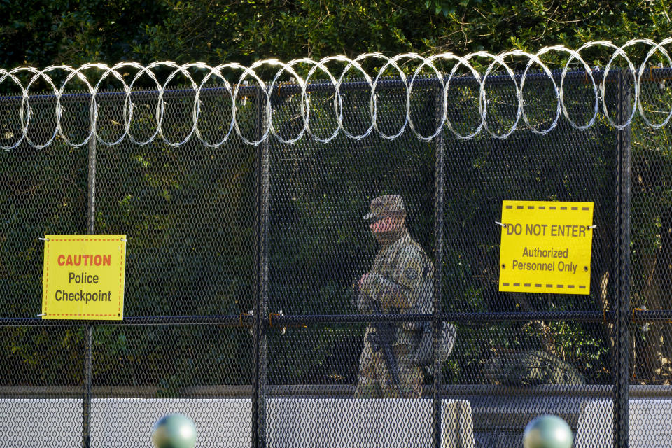 A National Guard member keeps watch along Constitution Avenue at the Capitol where heightened security remains since the Jan. 6 attacks by a mob of supporters of then-President Donald Trump, in Washington, Wednesday, March 3, 2021. The U.S. Capitol Police say they have intelligence showing there is a "possible plot" by a militia group to breach the U.S. Capitol on Thursday. (AP Photo/J. Scott Applewhite)