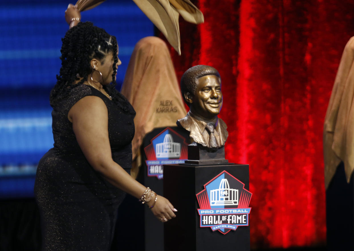 Cydney Nunn unveils the bust of her grandfather Bill Nunn during a Pro Football Hall of Fame Enshrinement ceremony in April. (Tom E. Puskar/AP Images for NFL)