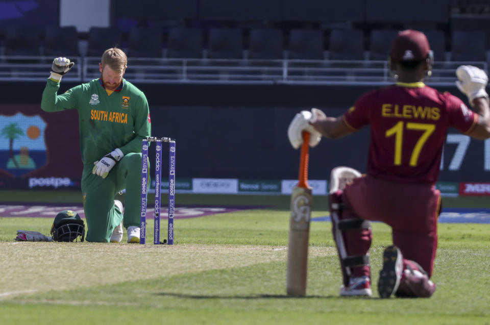 South Africa's Heinrich Klaasen, left, and West Indies' Evin Lewis take the knee prior to the start of the Cricket Twenty20 World Cup match between South Africa and the West Indies in Dubai, UAE, Tuesday, Oct. 26, 2021. (AP Photo/Kamran Jebreili)