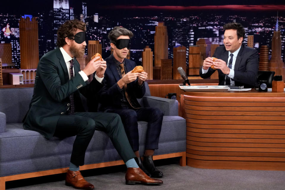 Comedians Rhett & Link try the Popeye's chicken sandwich during their interview with host Jimmy Fallon on October 29, 2019. | NBC—NBCU Photo Bank via Getty Images