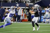 Dallas Cowboys cornerback Jourdan Lewis (26) defends as Las Vegas Raiders wide receiver Hunter Renfrow (13) catches a pass for a long gain in the second half of an NFL football game in Arlington, Texas, Thursday, Nov. 25, 2021. (AP Photo/Michael Ainsworth)