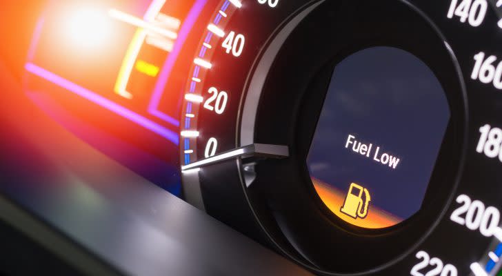 Close up empty Petrol, gasoline gauge dash board in car with digital warning sign of run out of fuel turn on on black background. Low level of fuel show on speedometer dashboard.