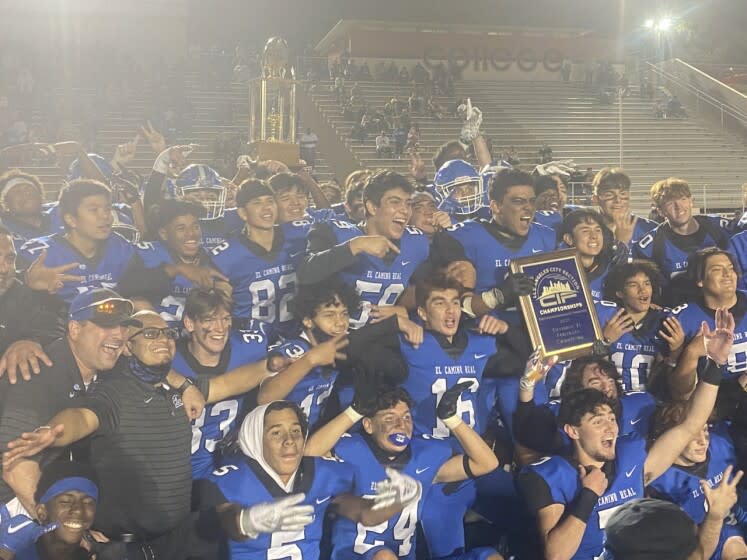 El Camino Real players celebrate a 37-18 victory over Hamilton to win City Section Division II title.