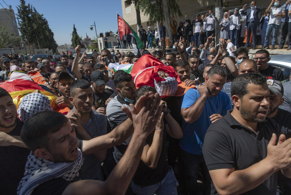 Palestinian mourners carry the bodies of Islam Bernat, 16, left and Adham Kashef, 20, during their funeral in the West Bank city of Ramallah, Wednesday, May 19, 2021. Multiple protesters were killed and more than 140 wounded in clashes with Israeli troops in Ramallah, Bethlehem, Hebron and other cities on Tuesday, according to the Palestinian Health Ministry. The Israeli army said at least a few soldiers were wounded in Ramallah by gunshots to the leg. (AP Photo/Nasser Nasser)