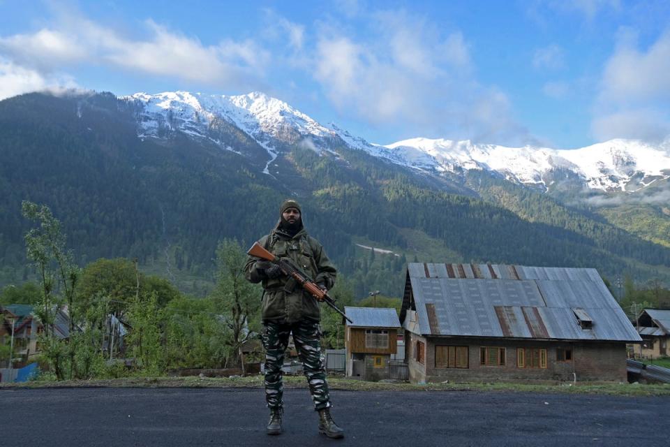 An Indian security personnel stands guard near a polling station during the fourth phase of voting in India’s general election, at Rayil village in Ganderbal district, northeast of Srinagar (AFP via Getty Images)
