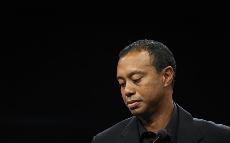 Tiger Woods looks down during a news conference at the Newseum in Washington, Monday, March 24, 2014. Woods discussed a deal through 2017 for his tournament to be called the Quicken Loans National to be played at Congressional in Bethesda, Md., in June. (AP Photo/Susan Walsh)