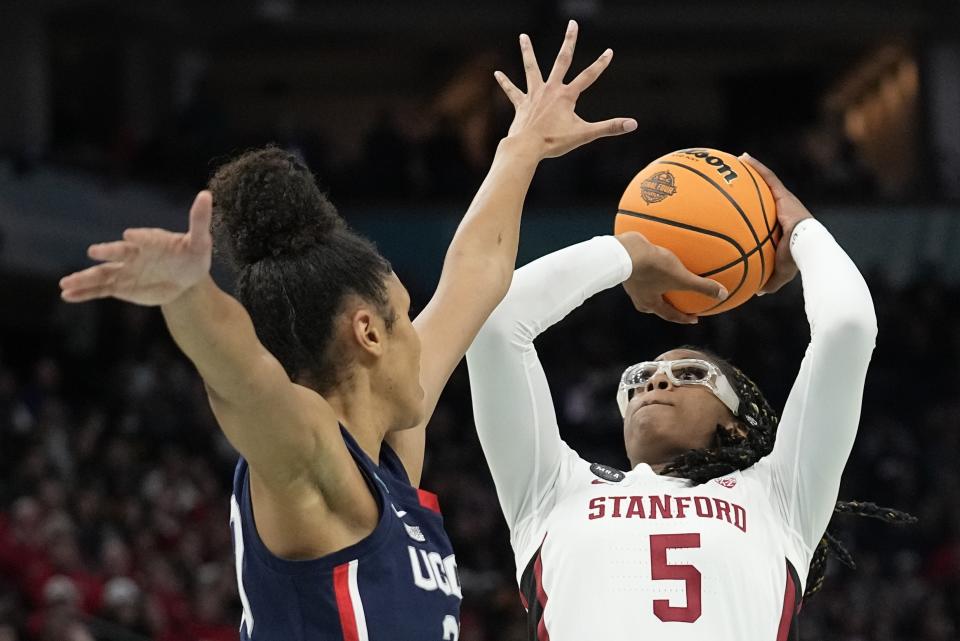 Stanford's Francesca Belibi tries to shoot past UConn's Olivia Nelson-Ododa during the first half of a college basketball game in the semifinal round of the Women's Final Four NCAA tournament Friday, April 1, 2022, in Minneapolis. (AP Photo/Eric Gay)