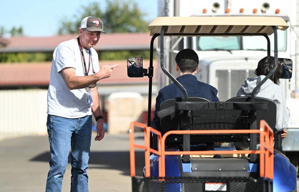 Teacher David Dein helps student Edwin Paniagua during a trailer backing exercise at Patterson High School in Patterson, Calif., Friday, Oct. 27, 2023. The school has career technical education class to teach trucking and help students gain a commercial drivers permit.