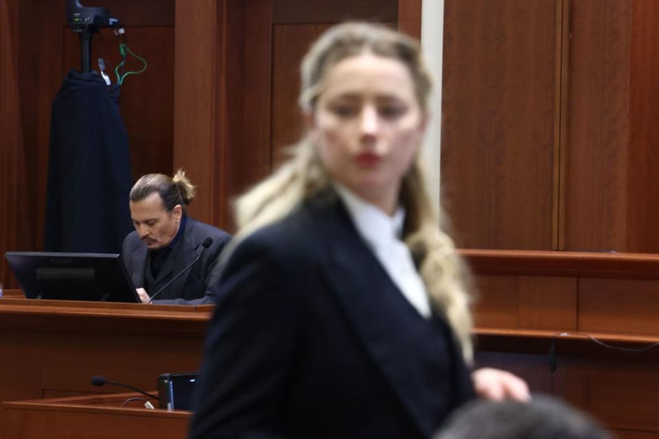 <div class="inline-image__caption"><p>Amber Heard speaks to her legal team as Johnny Depp returns to the stand during their defamation on April 21.</p></div> <div class="inline-image__credit">Jim Lo Scalzo/AFP/Getty</div>