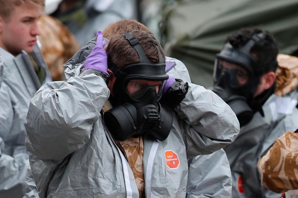 Military personnel wearing protective coveralls carry out their work in Salisbury (AFP)