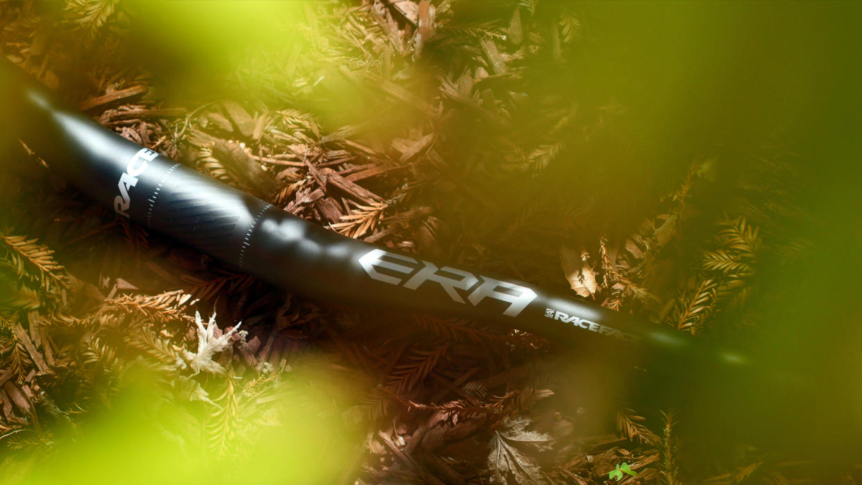  Race Face Era handlebar against a wood chip back drop. 